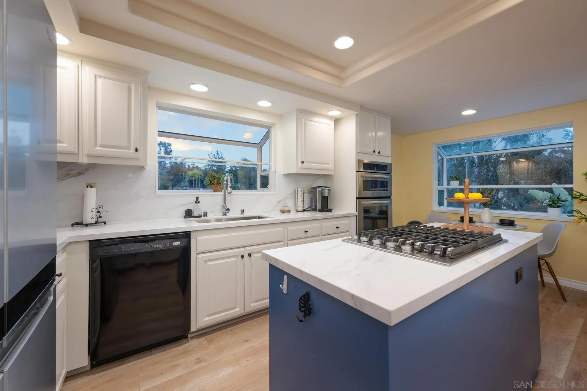 10575 Spruce Grove Avenue San Diego, CA 92131 - Photo 5 of 33 a kitchen with a sink a stove top oven a counter space and cabinets