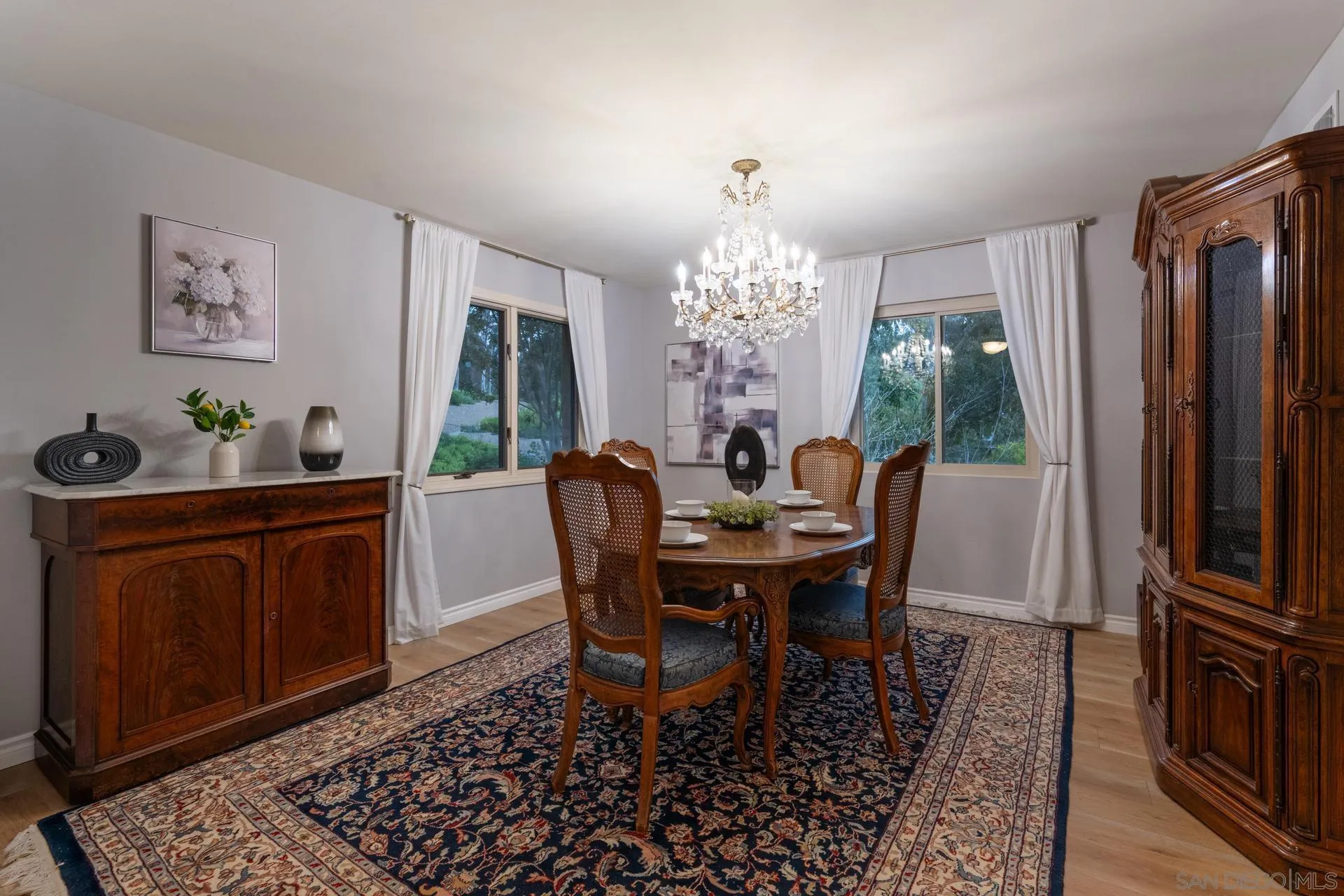 10575 Spruce Grove Avenue San Diego, CA 92131 - Photo 8 of 33 a dining room with furniture a chandelier and wooden floor