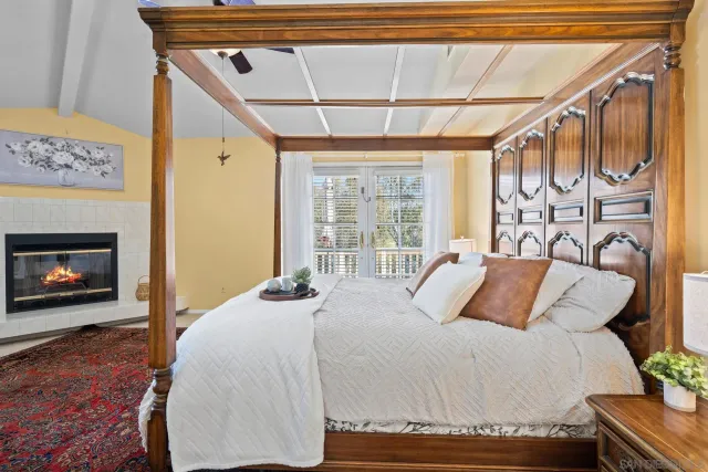 a bedroom with a bed and a fireplace