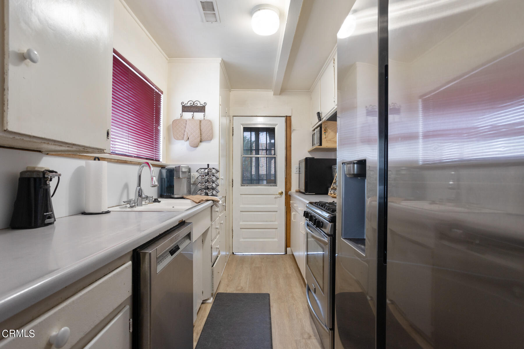 7518 Kyle Street Tujunga, CA 91042 - Photo 12 of 28 a kitchen with a refrigerator and cabinets