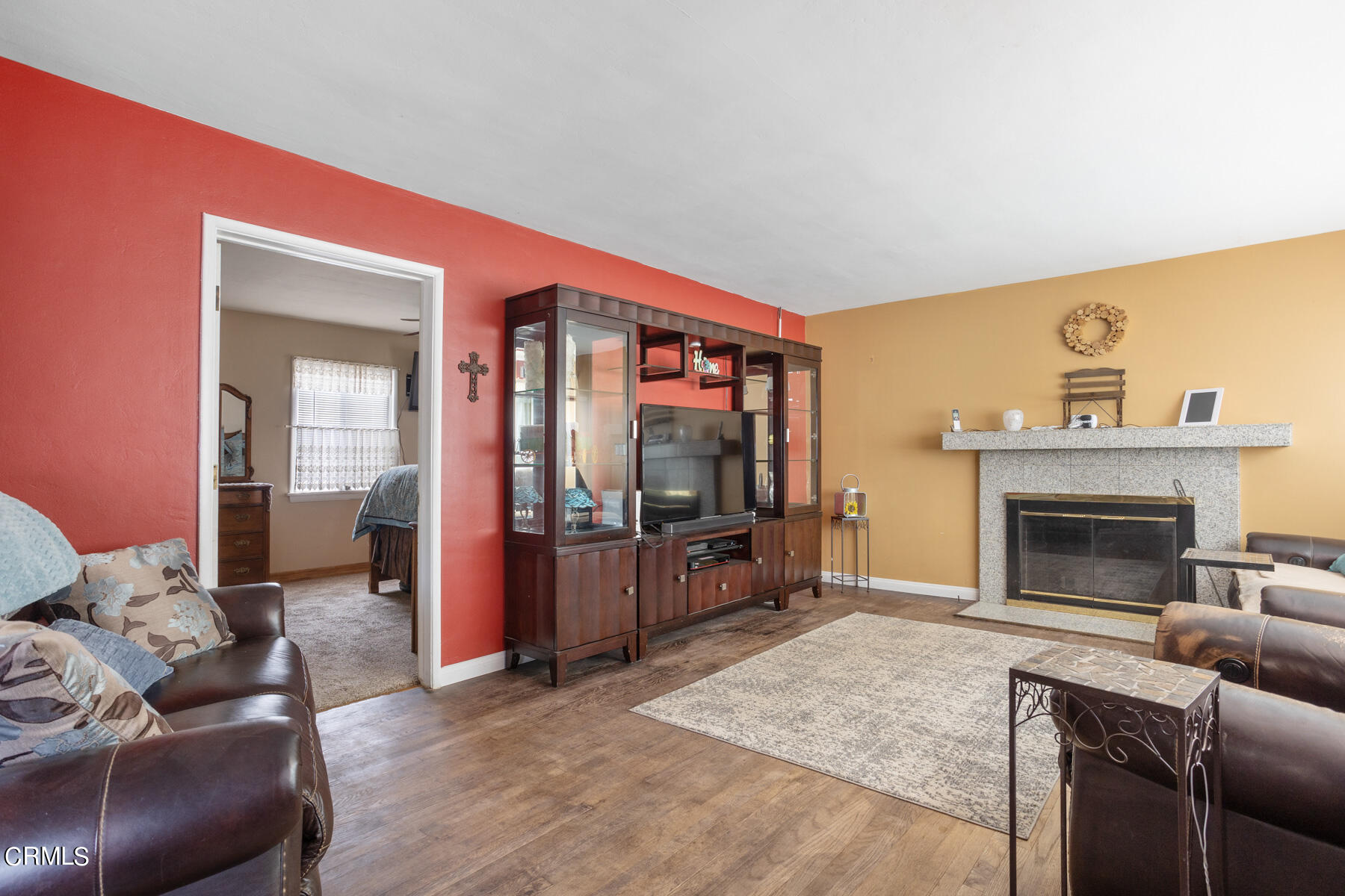 7518 Kyle Street Tujunga, CA 91042 - Photo 4 of 28 a living room with furniture a flat screen tv and a fireplace