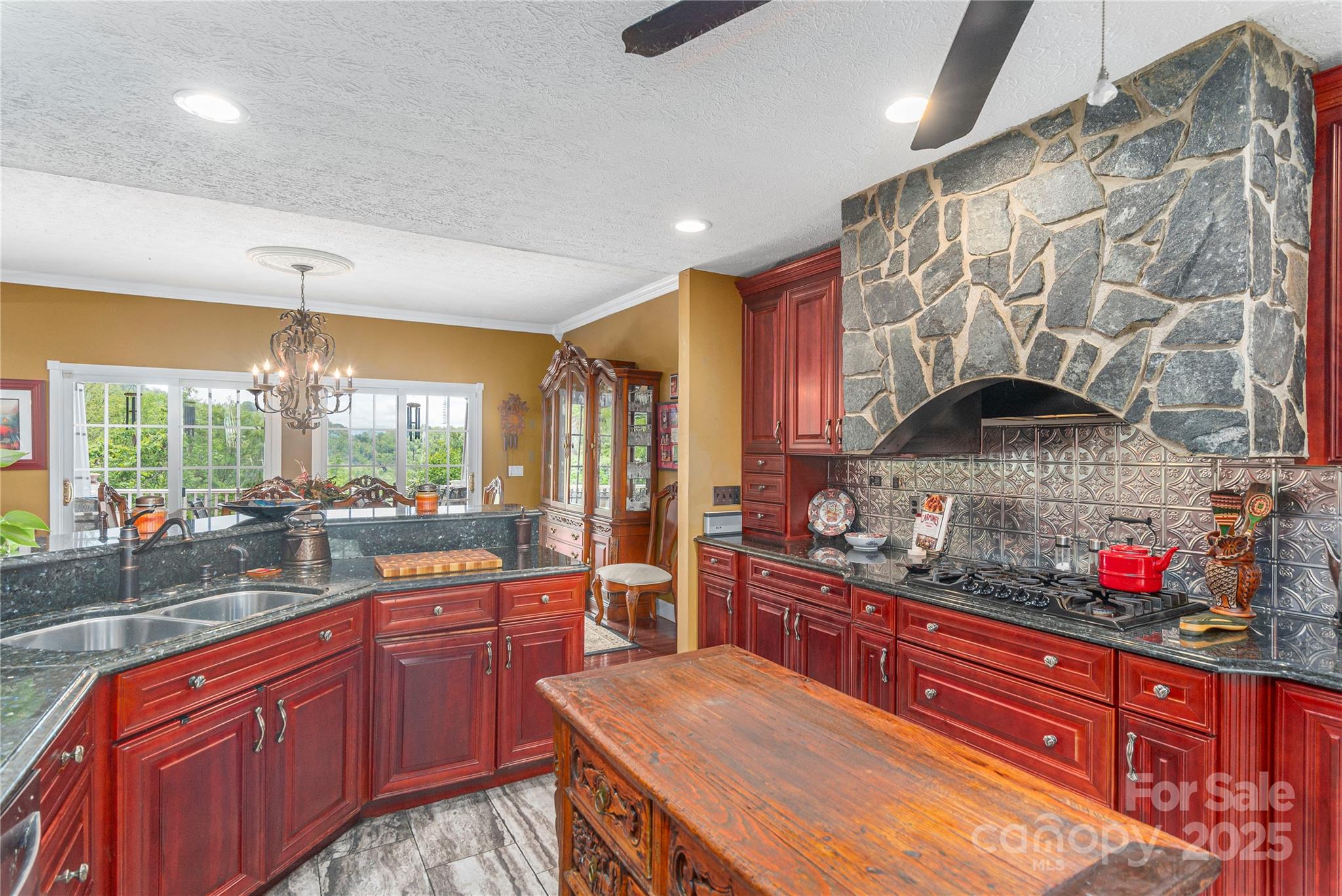 1706 Rock House Cove Road Clyde, NC 28721 - Photo 13 of 40 a kitchen with stainless steel appliances granite countertop a sink and wooden cabinets