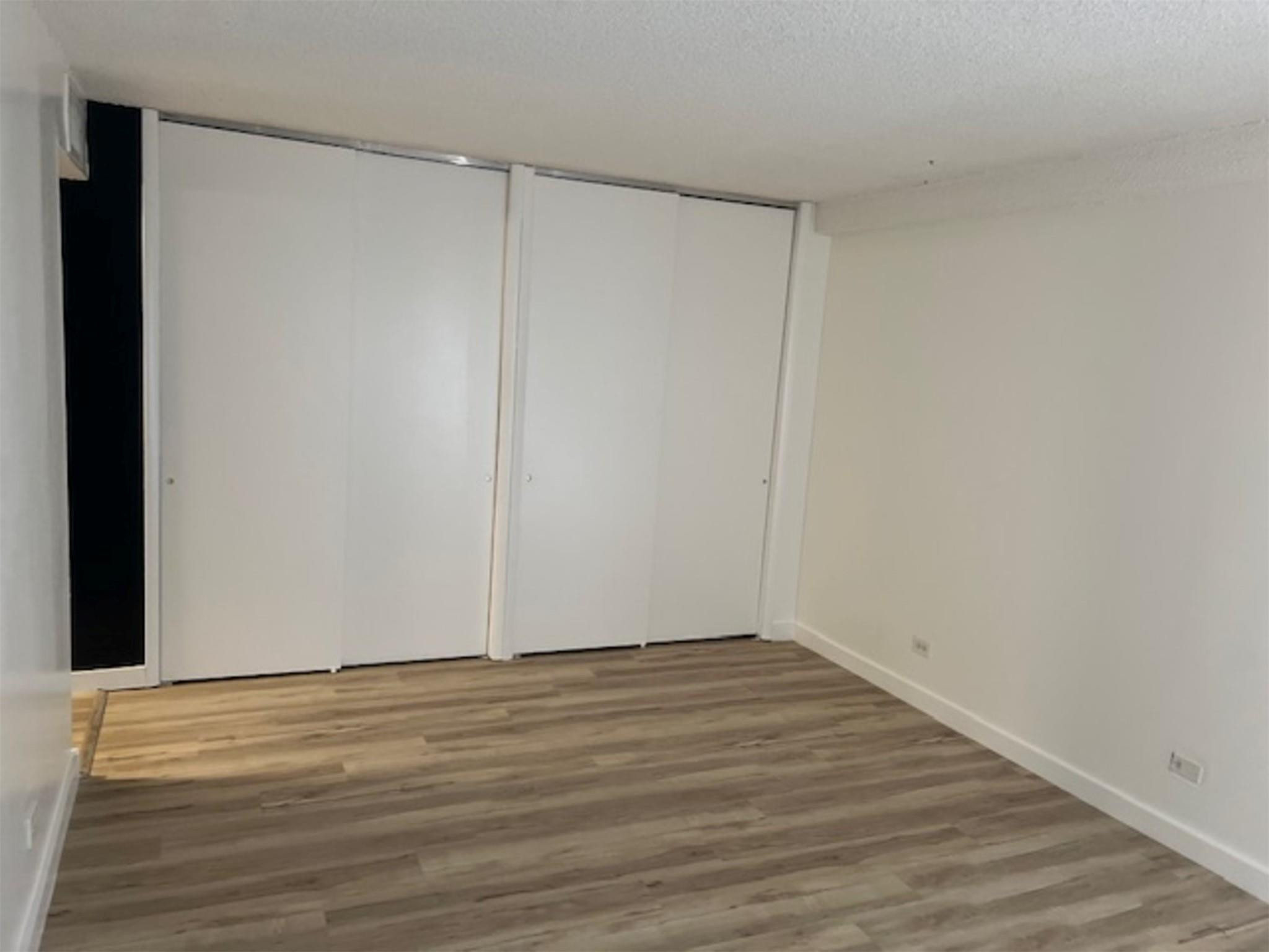 3720 Inverrary Drive, Unit 1T Lauderhill, FL 33319 - Photo 13 of 36 a view of an empty room with wooden floor