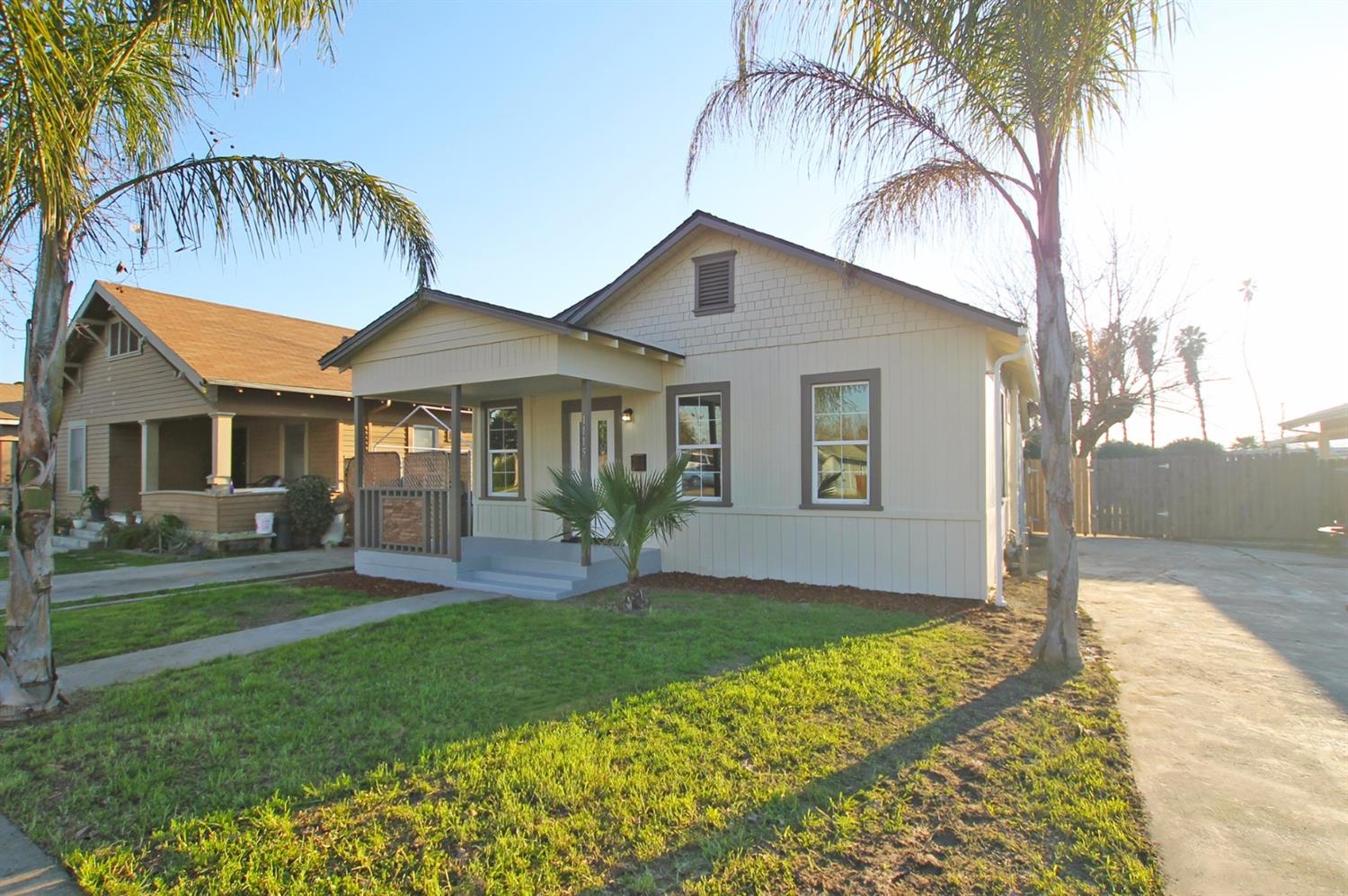 1115 M Street Reedley, CA 93654 - Photo 2 of 10 a front view of a house with a garden and yard