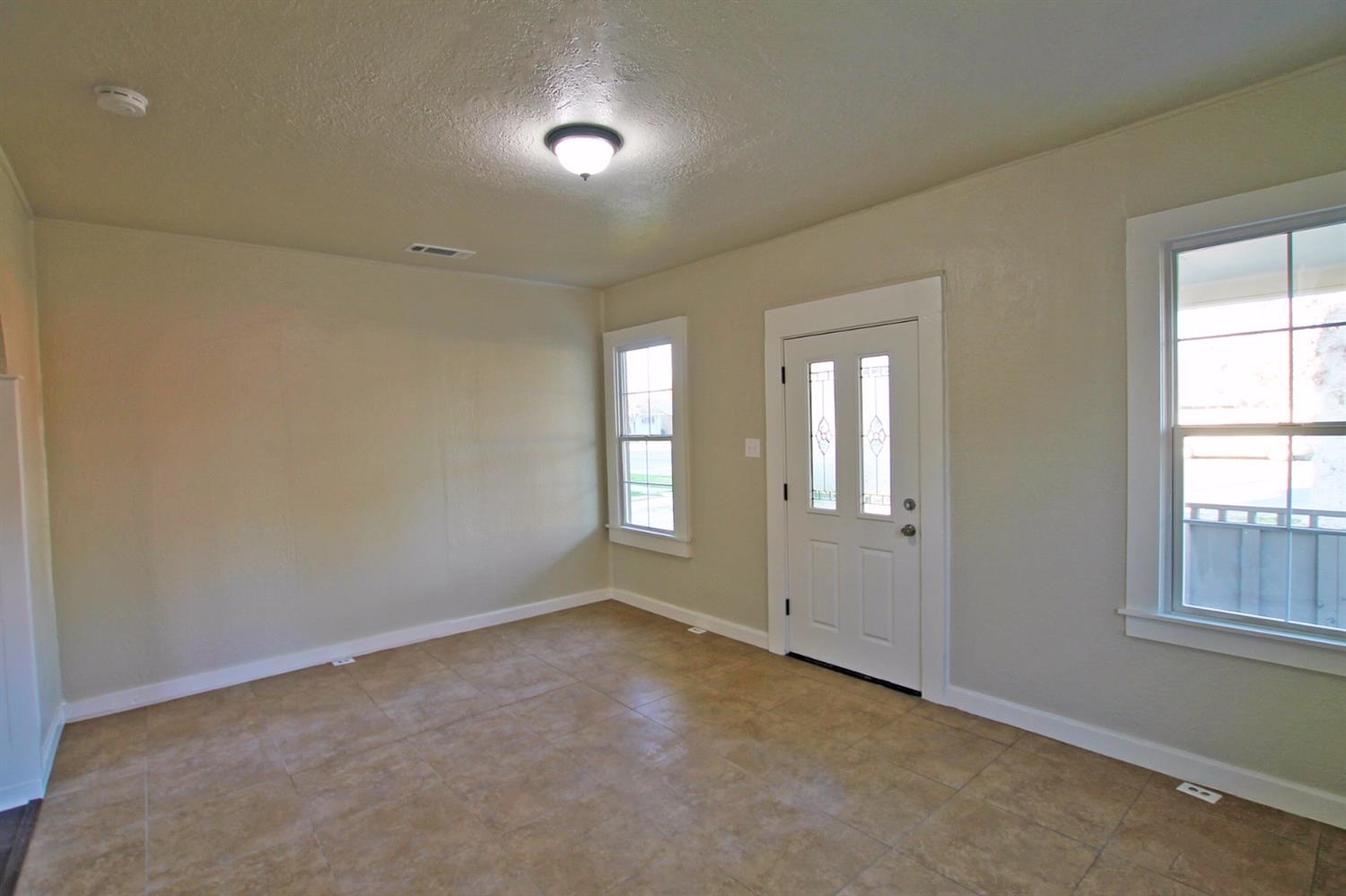 1115 M Street Reedley, CA 93654 - Photo 6 of 10 a view of an empty room with a window