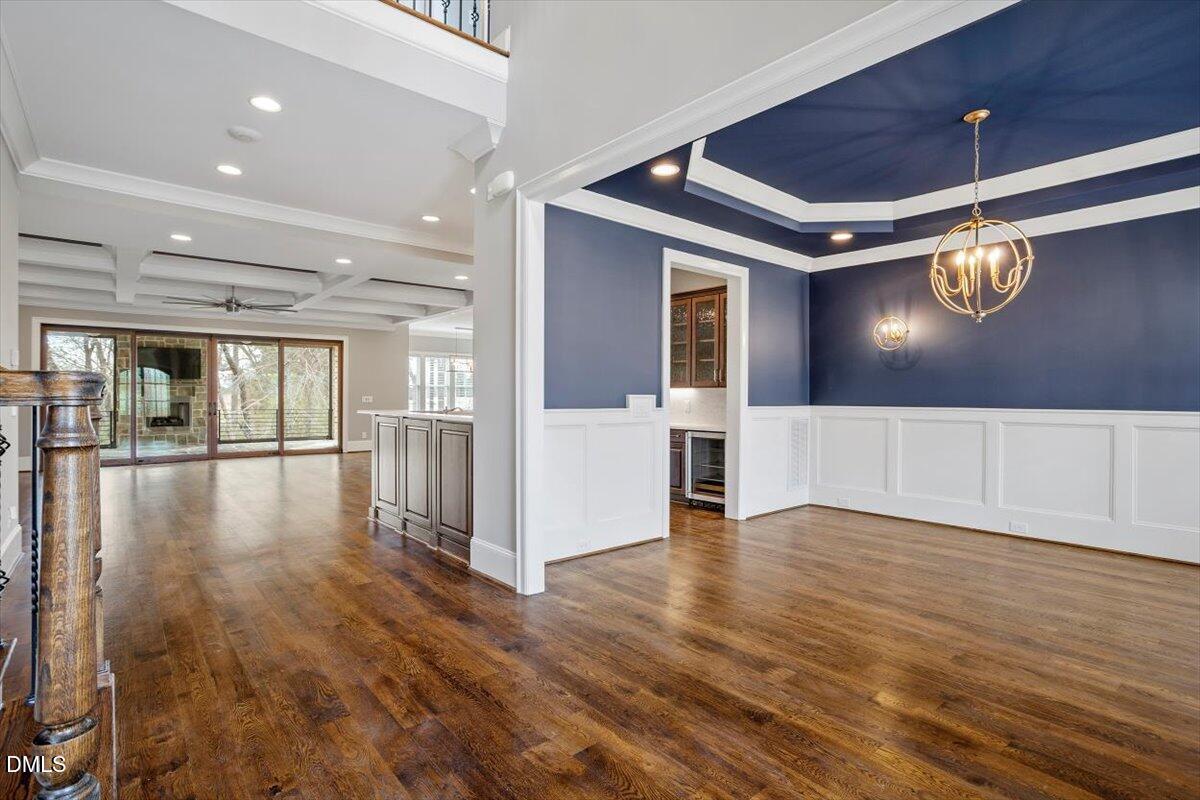 12616 Village Springs Road Raleigh, NC 27614 - Photo 11 of 89 a view of an empty room with wooden floor and a ceiling fan