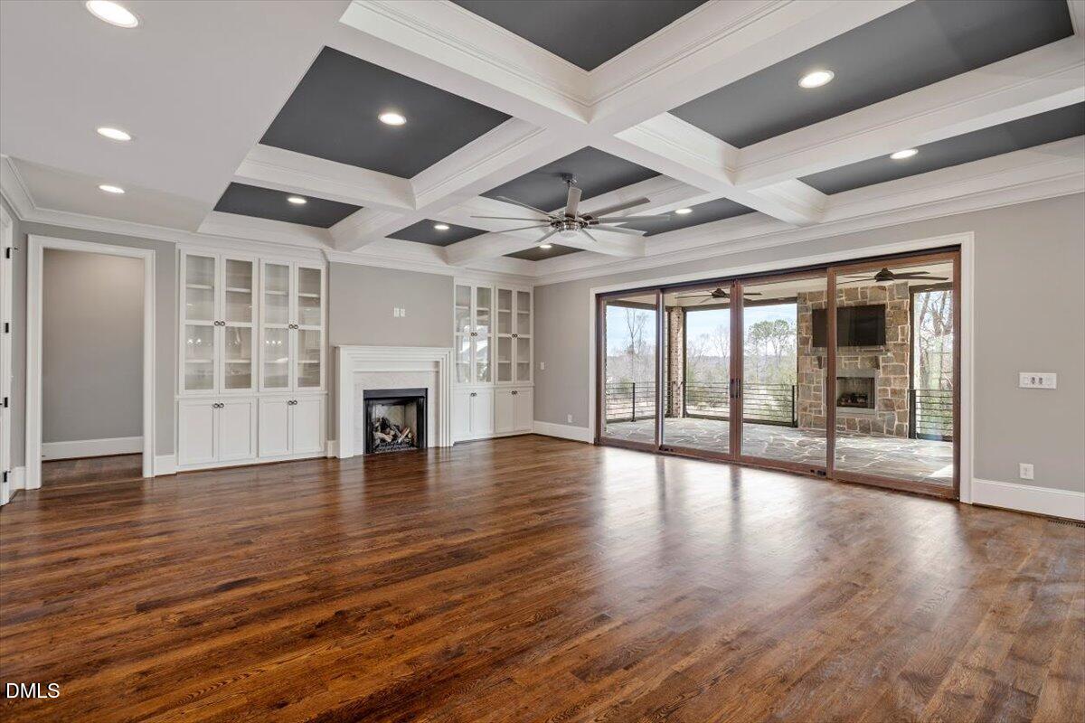 12616 Village Springs Road Raleigh, NC 27614 - Photo 20 of 89 a view of an empty room with wooden floor and a fireplace