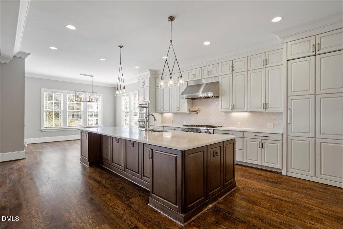 12616 Village Springs Road Raleigh, NC 27614 - Photo 26 of 89 a kitchen with stainless steel appliances granite countertop a stove a sink dishwasher a refrigerator and white cabinets with wooden floor