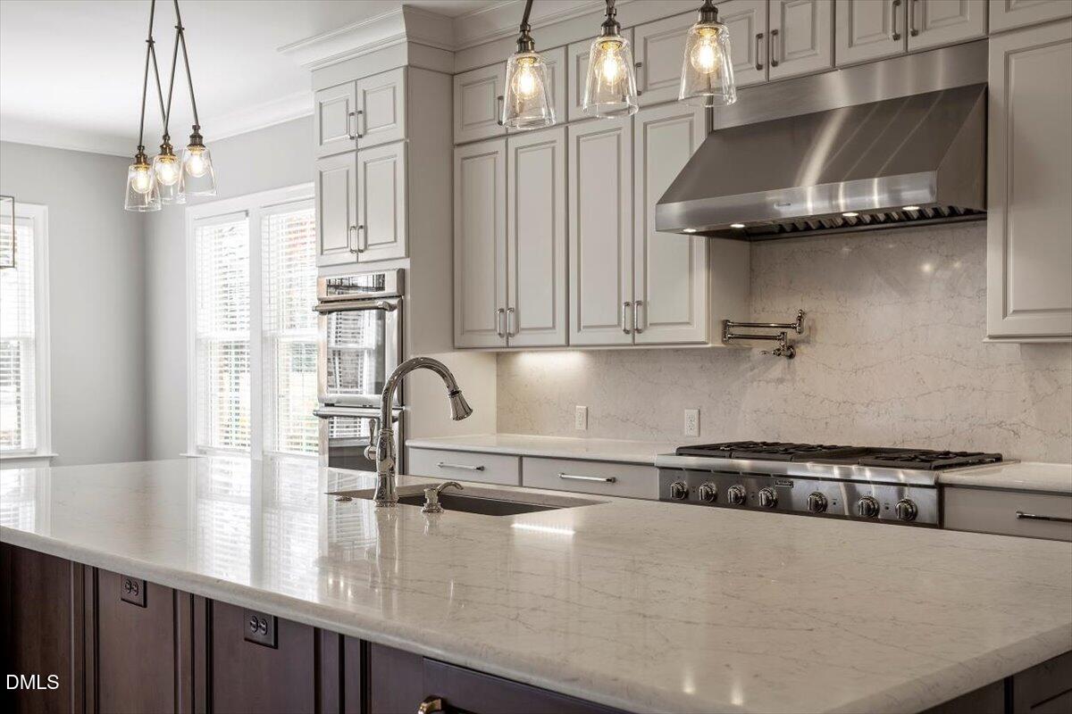 12616 Village Springs Road Raleigh, NC 27614 - Photo 27 of 89 a kitchen with stainless steel appliances granite countertop a sink a stove and a wooden floors