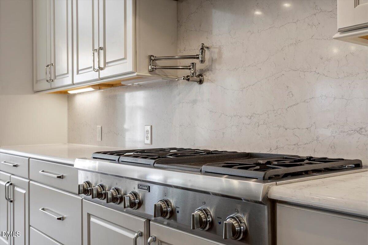 12616 Village Springs Road Raleigh, NC 27614 - Photo 29 of 89 a stove top oven sitting inside of a kitchen