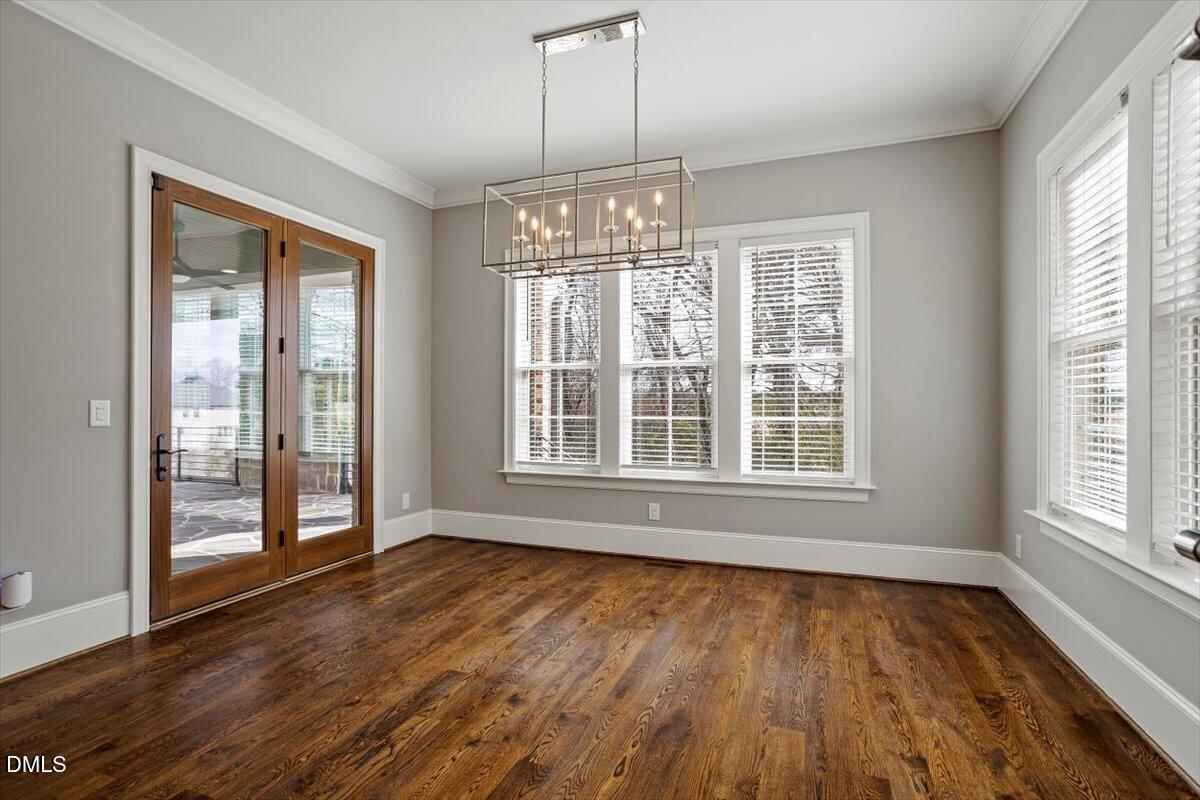 12616 Village Springs Road Raleigh, NC 27614 - Photo 30 of 89 a view of an empty room with wooden floor and a window