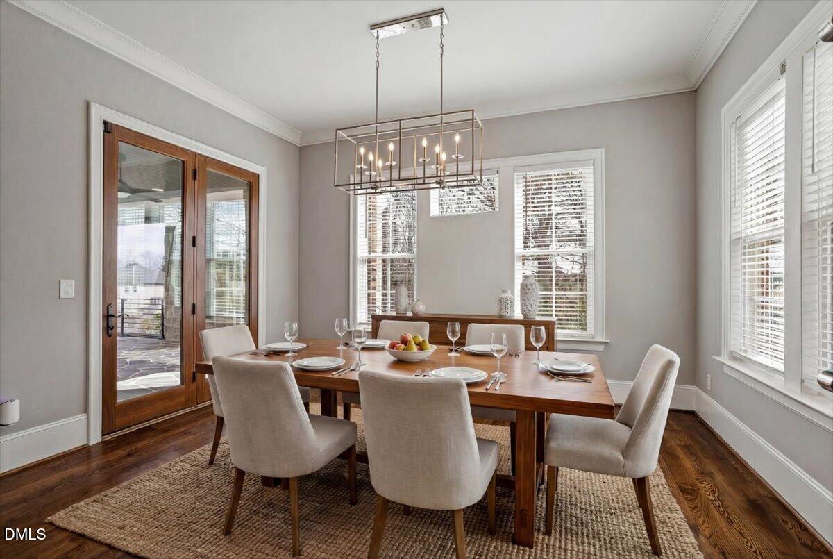 12616 Village Springs Road Raleigh, NC 27614 - Photo 31 of 89 a dining room with furniture a chandelier and wooden floor