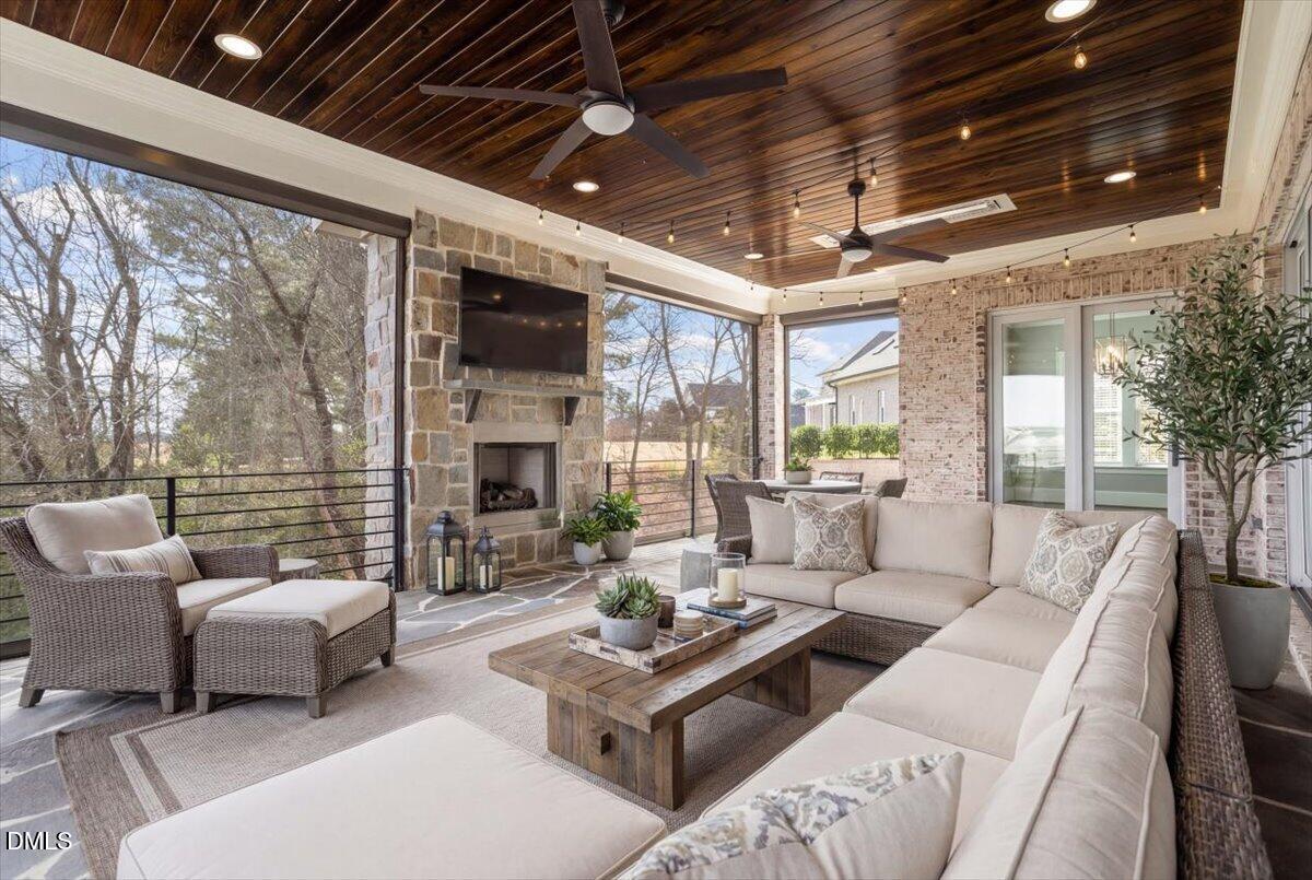 12616 Village Springs Road Raleigh, NC 27614 - Photo 34 of 89 a living room with furniture a fireplace and a table