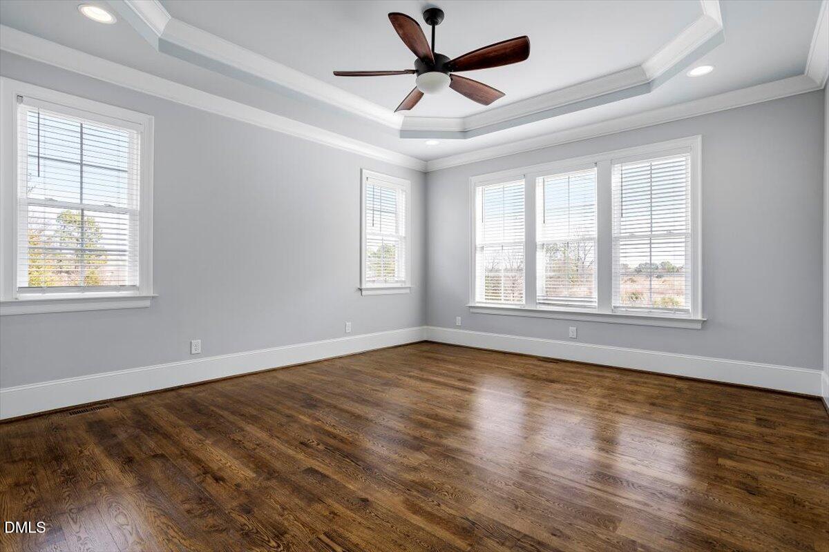12616 Village Springs Road Raleigh, NC 27614 - Photo 42 of 89 a view of an empty room with wooden floor and a window