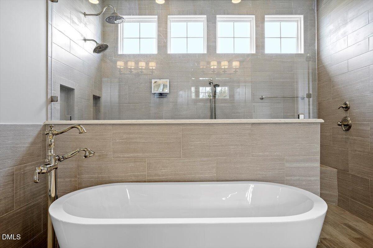 12616 Village Springs Road Raleigh, NC 27614 - Photo 45 of 89 a white bath tub sitting in a bathroom next to a window