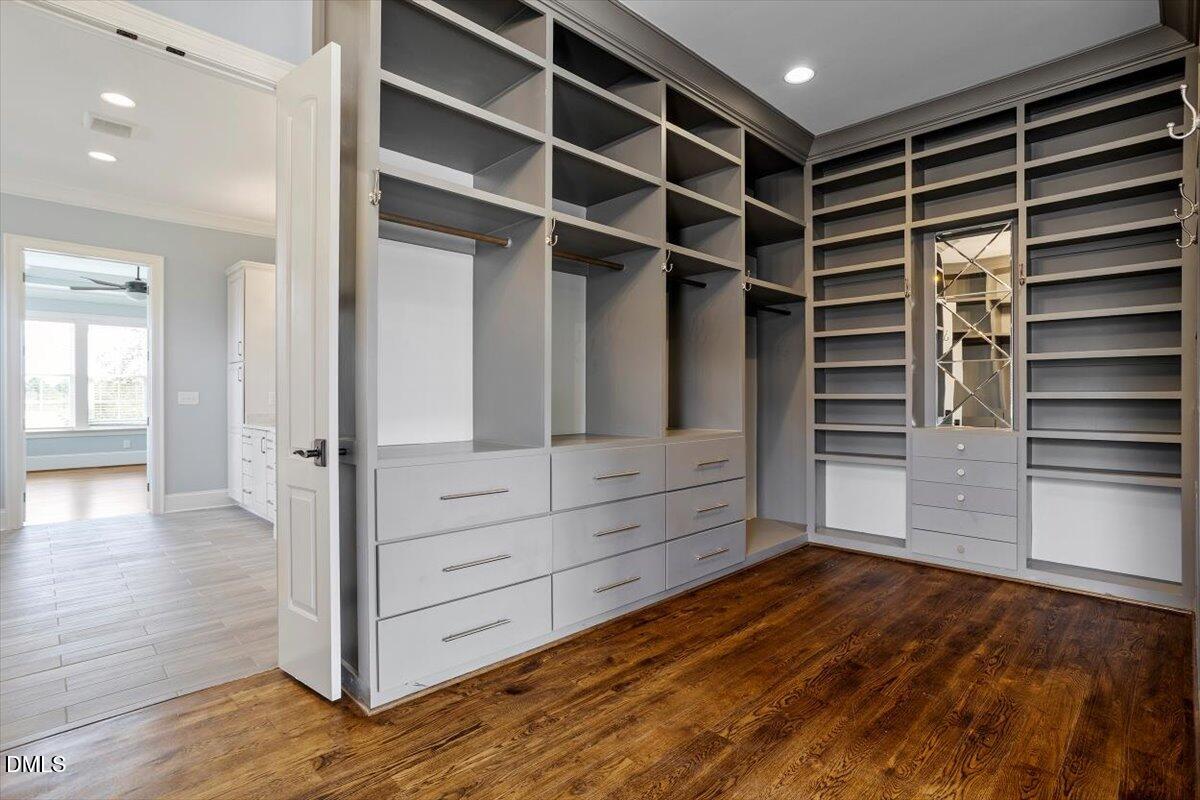 12616 Village Springs Road Raleigh, NC 27614 - Photo 47 of 89 a view of walk in closet with empty racks