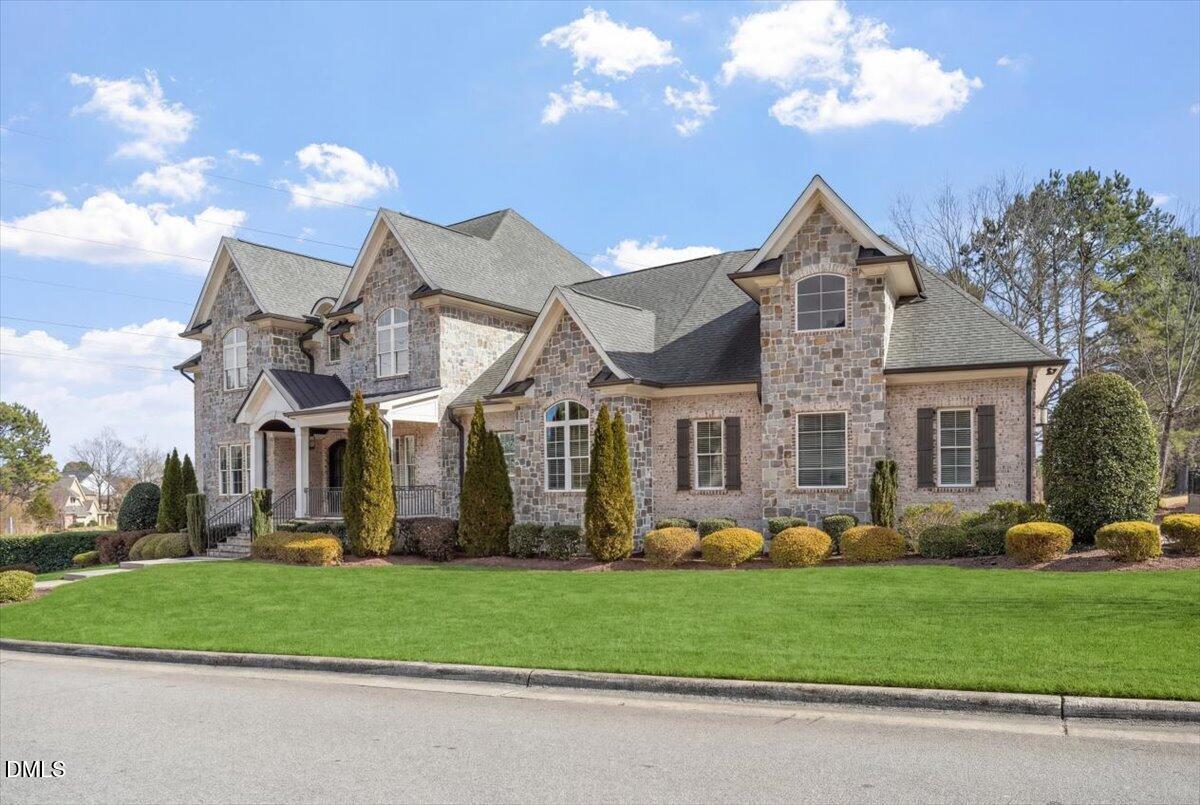 12616 Village Springs Road Raleigh, NC 27614 - Photo 4 of 89 a front view of a house with a garden