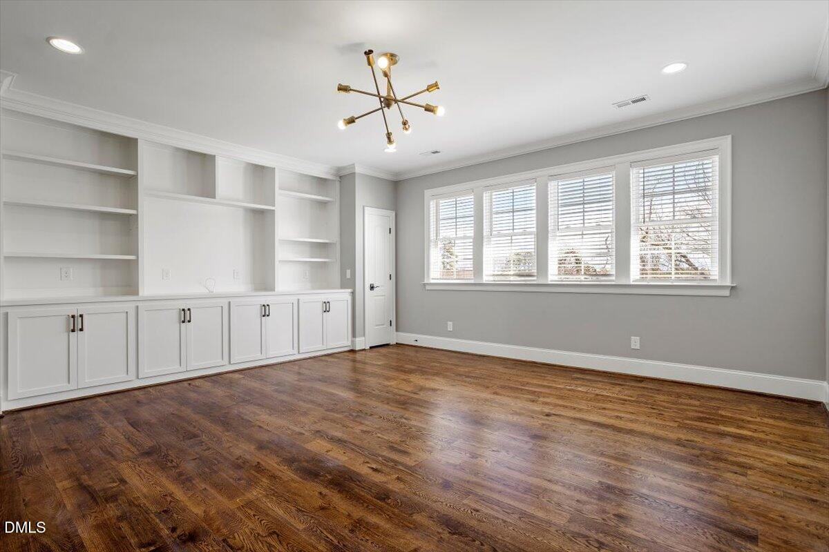12616 Village Springs Road Raleigh, NC 27614 - Photo 50 of 89 a view of an empty room with a window and wooden floor