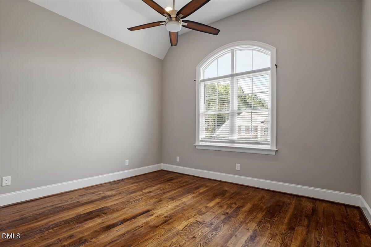 12616 Village Springs Road Raleigh, NC 27614 - Photo 56 of 89 an empty room with wooden floor windows and fan