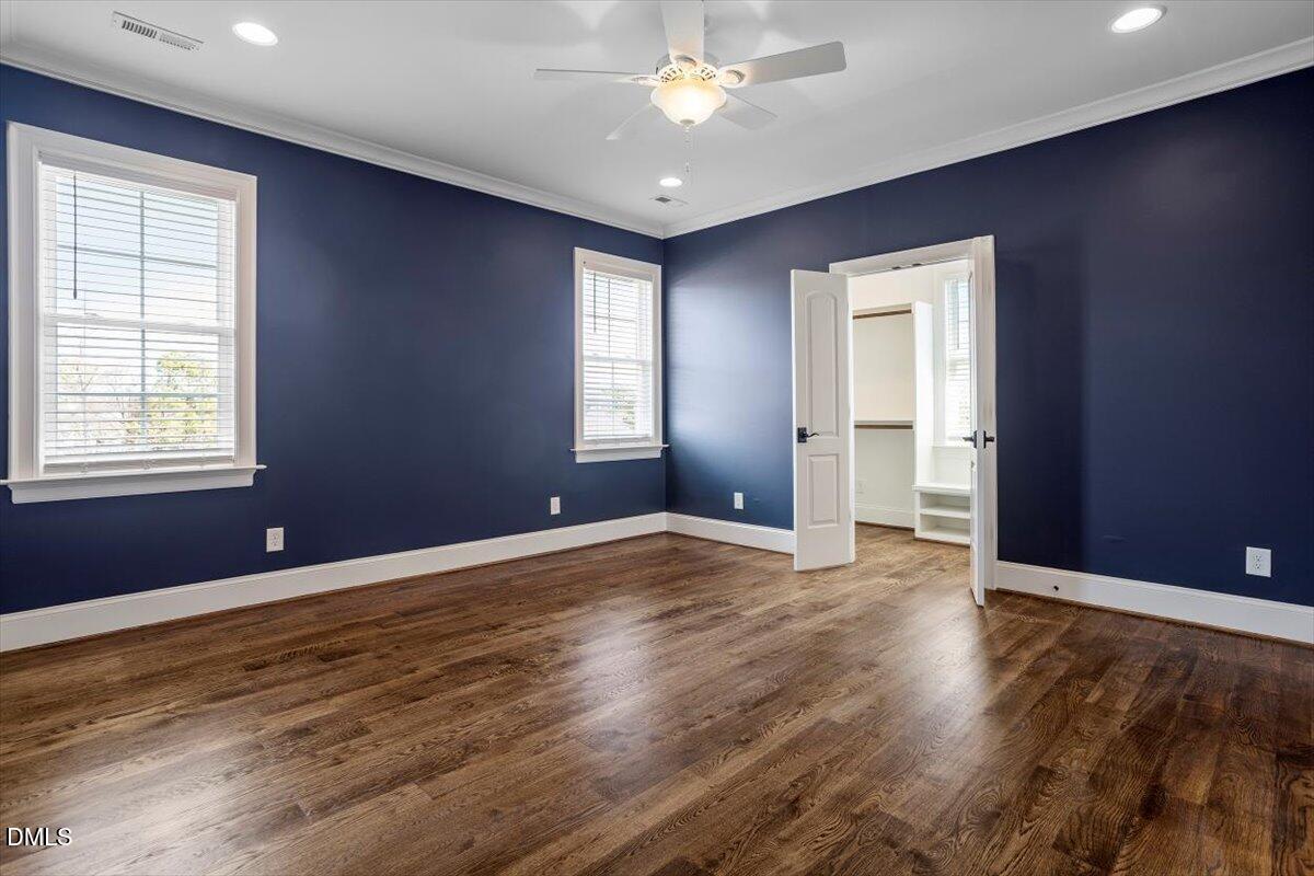 12616 Village Springs Road Raleigh, NC 27614 - Photo 58 of 89 a view of an empty room with window and wooden floor