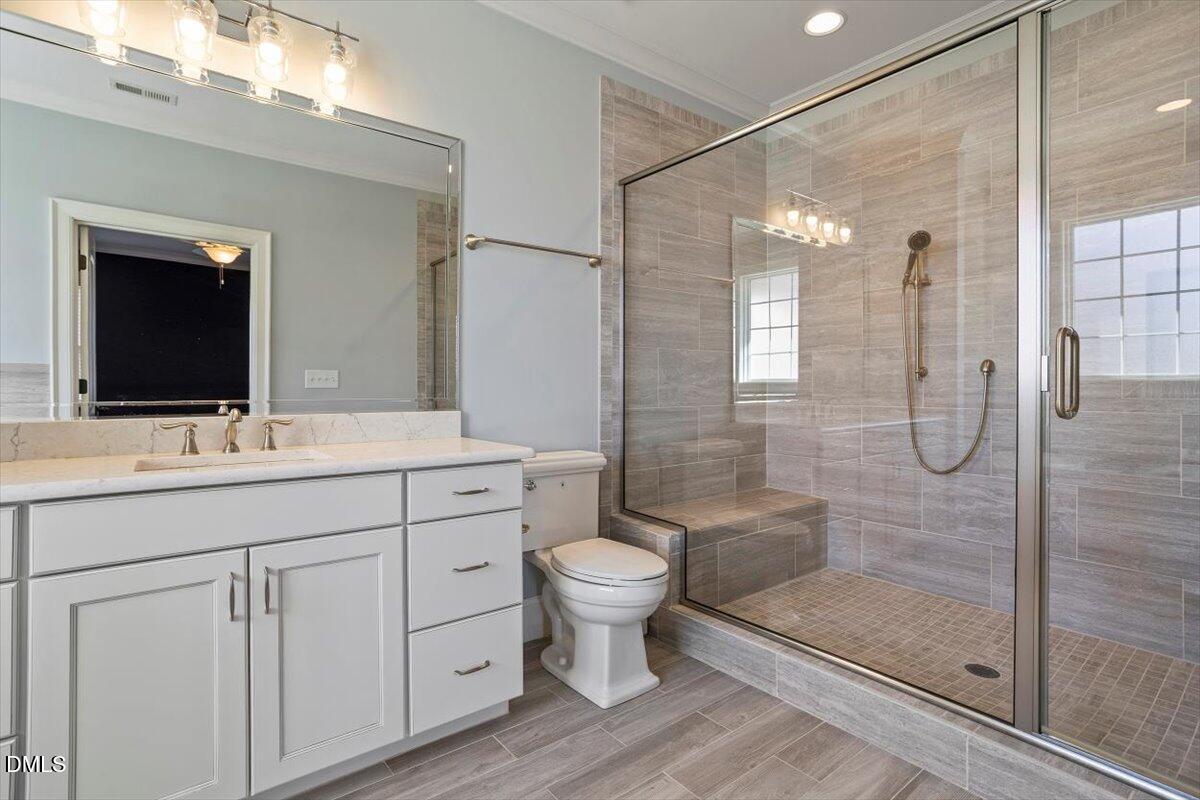 12616 Village Springs Road Raleigh, NC 27614 - Photo 61 of 89 a bathroom with a double vanity sink mirror and toilet