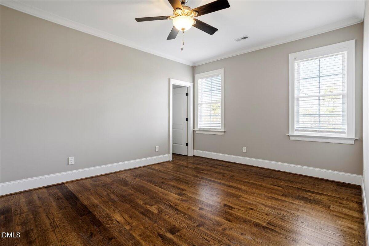 12616 Village Springs Road Raleigh, NC 27614 - Photo 63 of 89 a view of an empty room with window and wooden floor