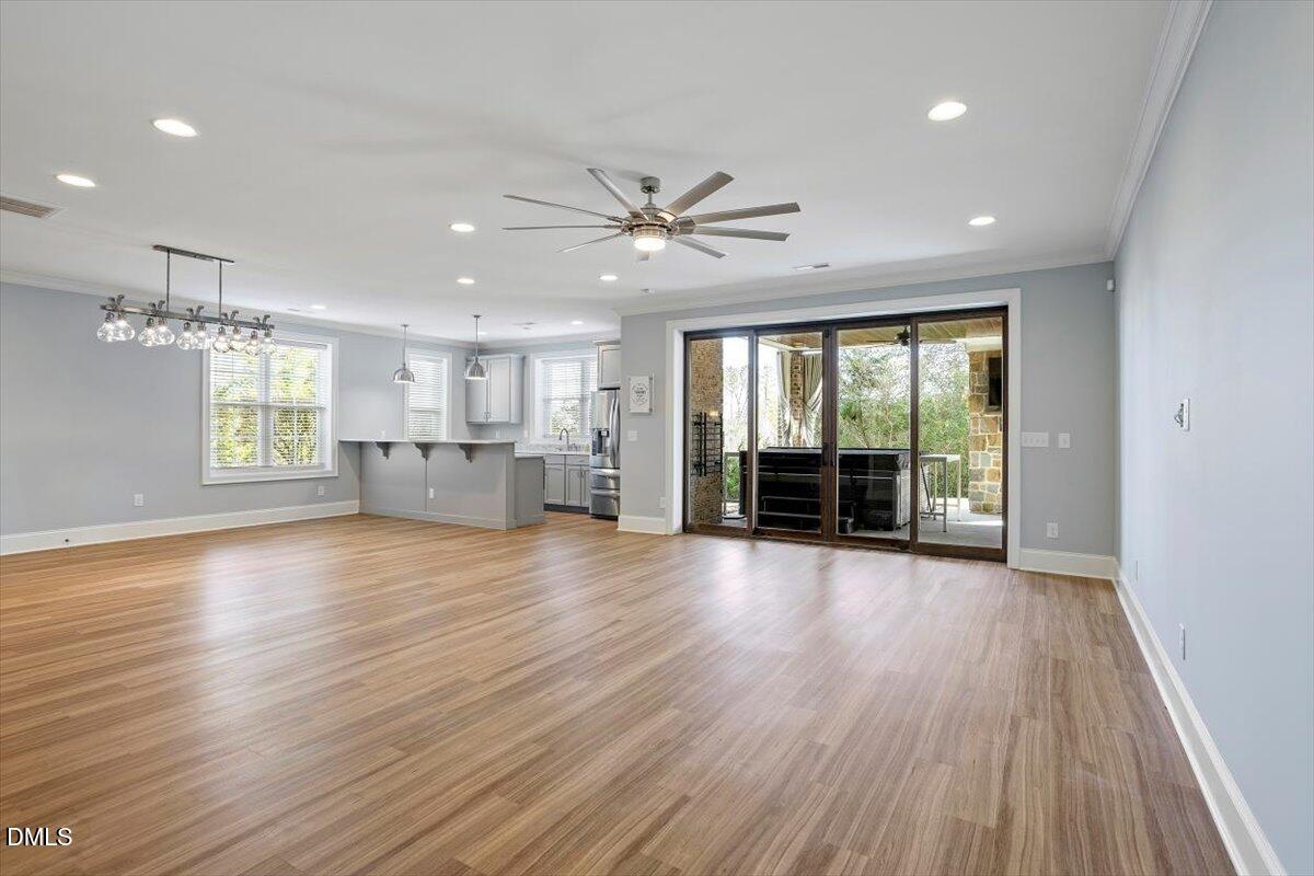 12616 Village Springs Road Raleigh, NC 27614 - Photo 69 of 89 a view of an empty room with window and wooden floor