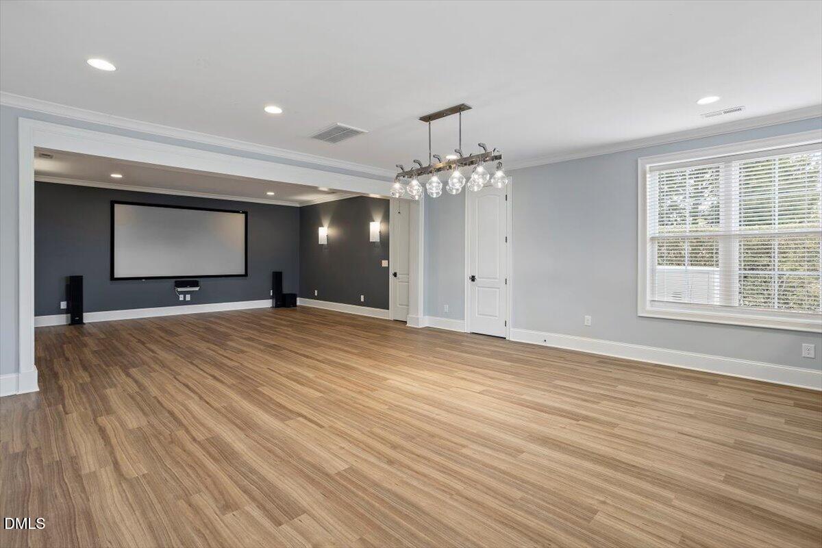 12616 Village Springs Road Raleigh, NC 27614 - Photo 73 of 89 a view of an empty room with wooden floor and a window