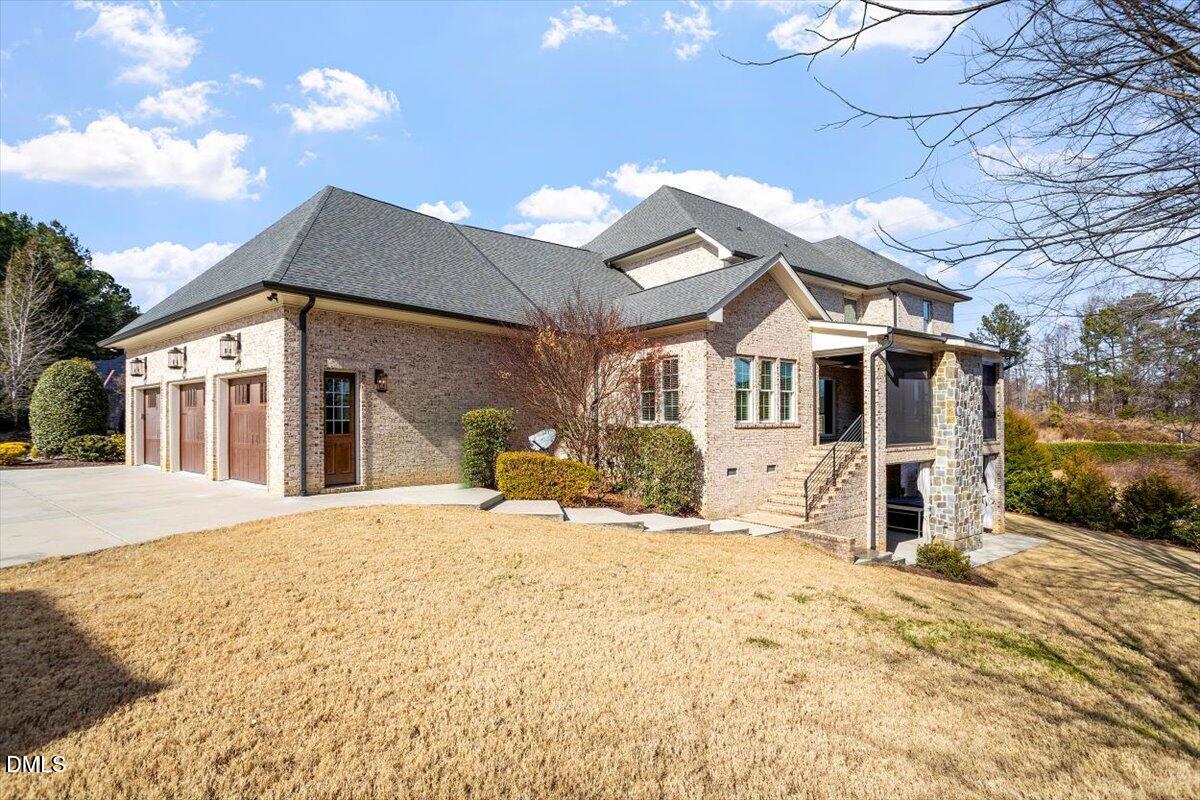 12616 Village Springs Road Raleigh, NC 27614 - Photo 7 of 89 a front view of a house with a yard covered in snow