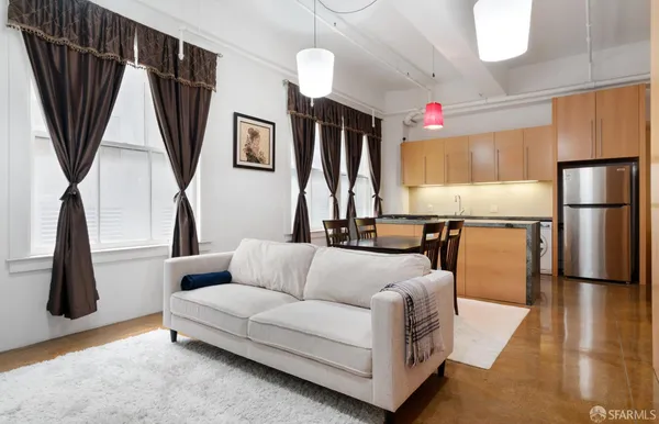 a living room with furniture a flat screen tv and a table
