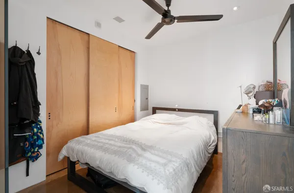 a bedroom with a bed and a couch