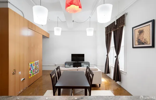 a view of a dining room with furniture and wooden floor