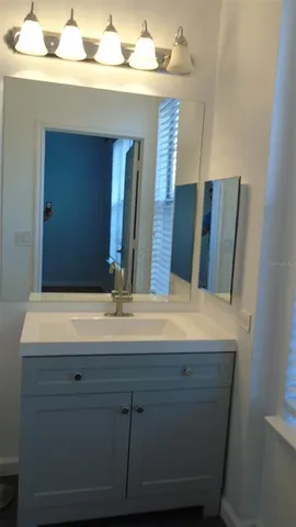 a bathroom with a sink and a mirror
