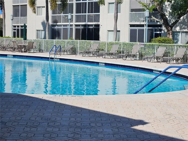 a view of swimming pool with outdoor seating and lake view