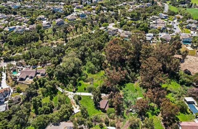 an aerial view of a houses with a yard