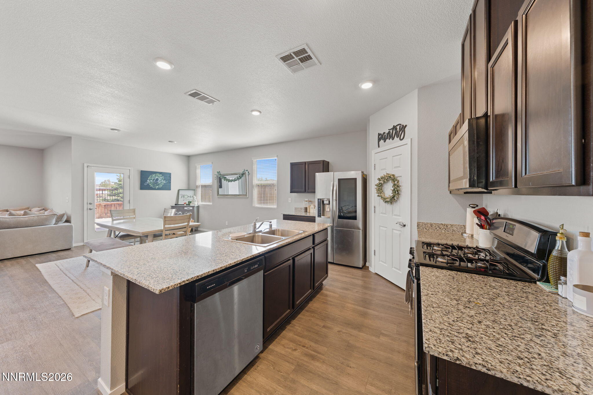 9708 Sea Glass Drive Reno, NV 89506 - Photo 34 of 51 a kitchen with stainless steel appliances granite countertop a sink stove and refrigerator
