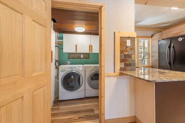 a view of entryway with wooden floor and door
