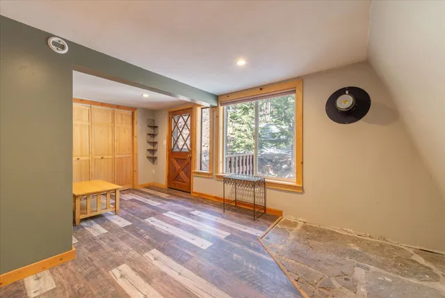 a view of a room with wooden floor and furniture