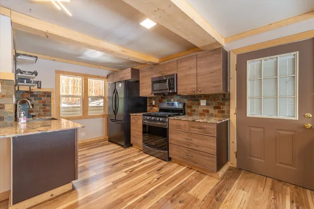 a kitchen with stainless steel appliances granite countertop a stove and a refrigerator