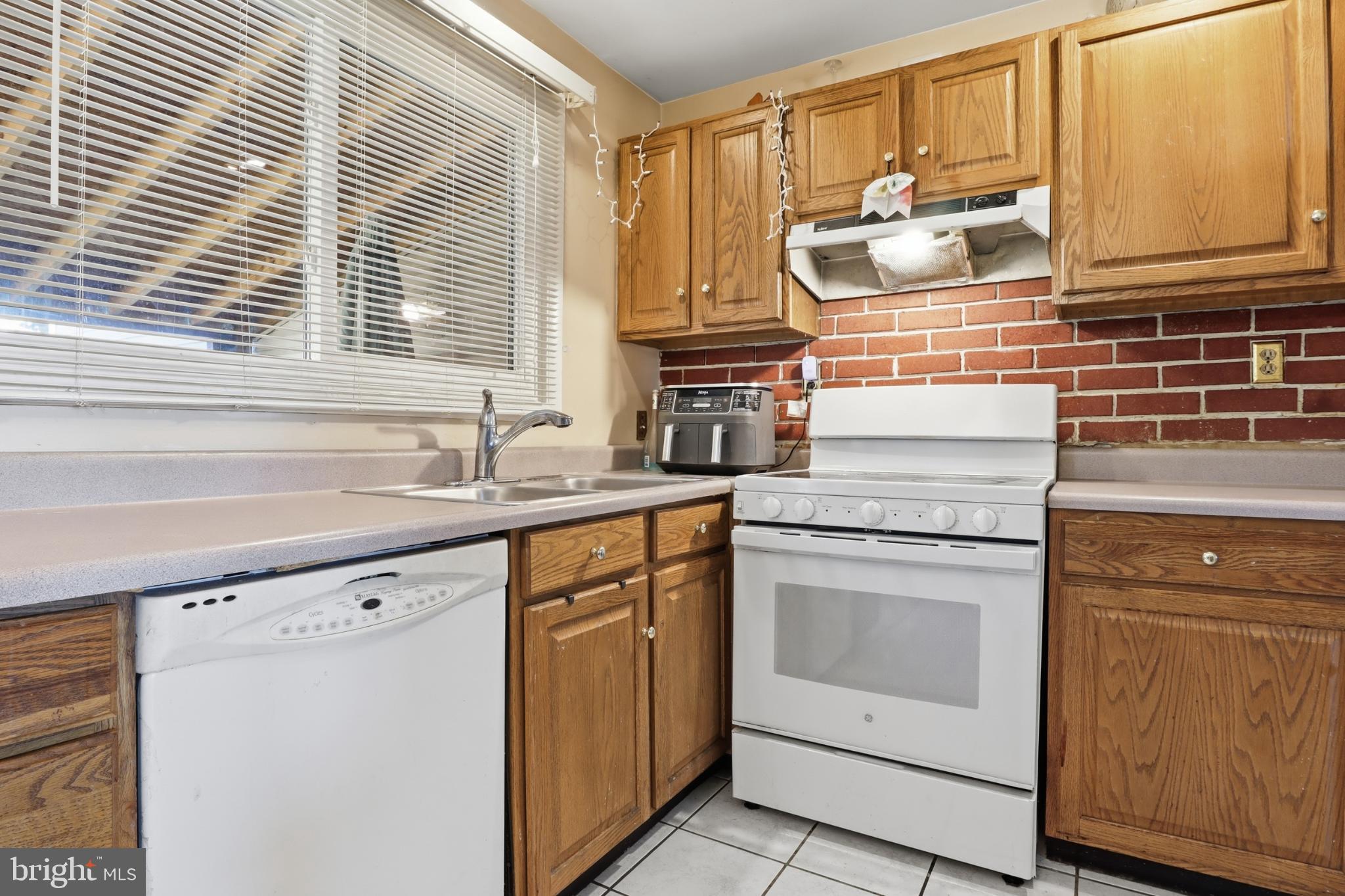 4849 Springtop Drive Harrisburg, PA 17111 - Photo 11 of 42 a kitchen with granite countertop white cabinets and white appliances