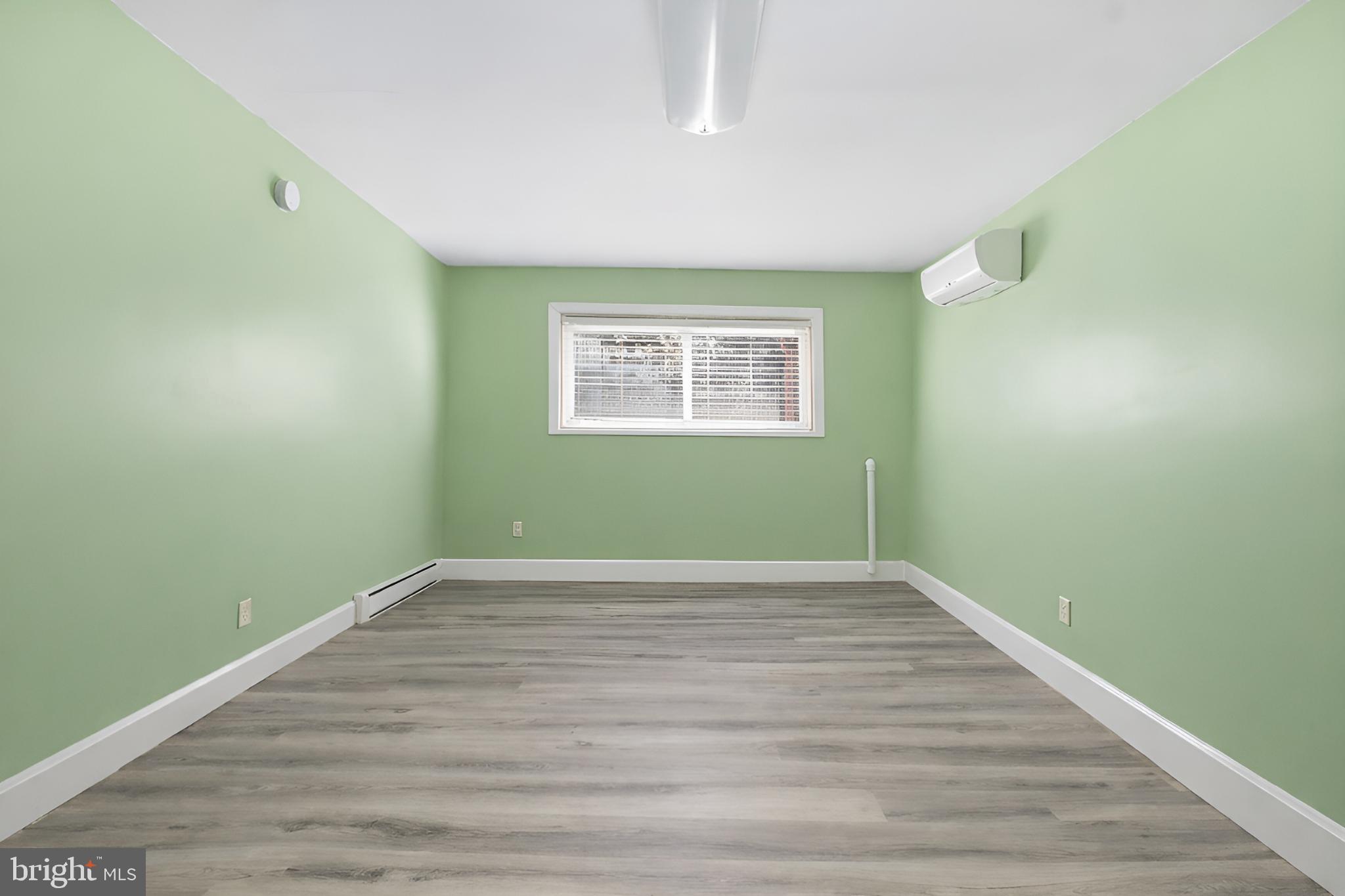 4849 Springtop Drive Harrisburg, PA 17111 - Photo 27 of 42 a view of an empty room with wooden floor and a window