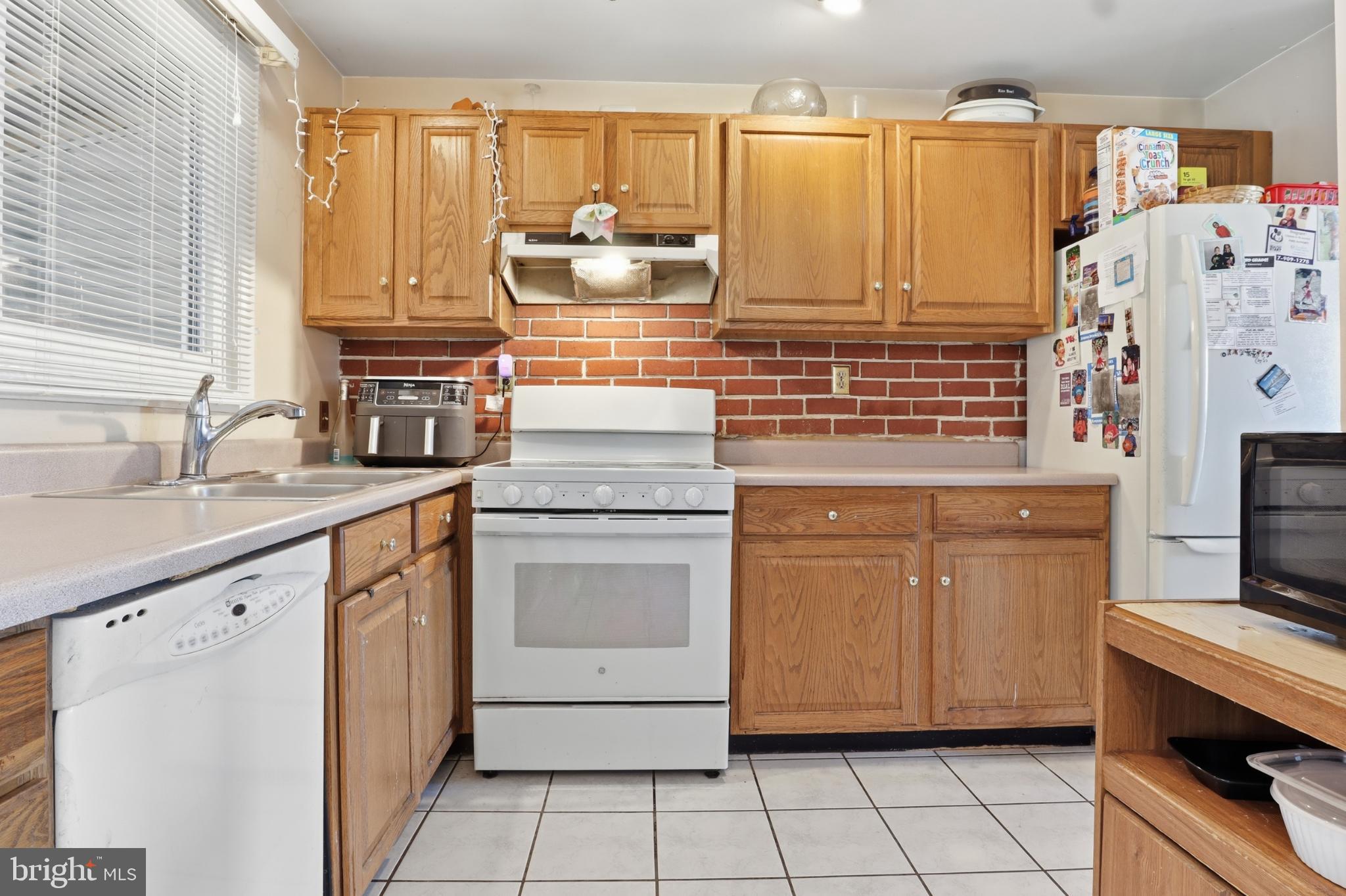 4849 Springtop Drive Harrisburg, PA 17111 - Photo 8 of 42 a kitchen with stainless steel appliances granite countertop a sink stove and refrigerator