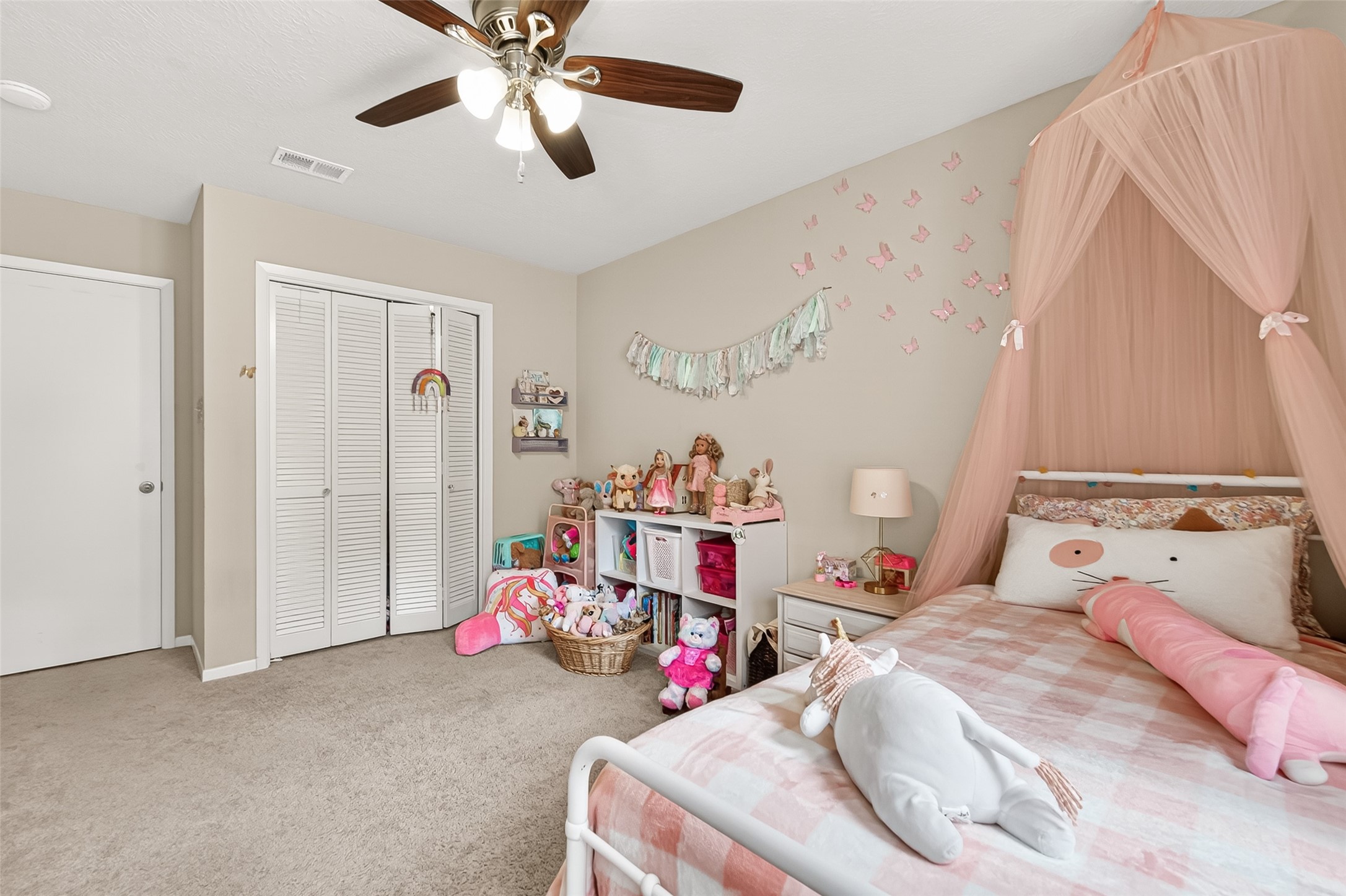 17611 Sorrell Ridge Drive Spring, TX 77388 - Photo 31 of 50 a bedroom with a bed and a chandelier