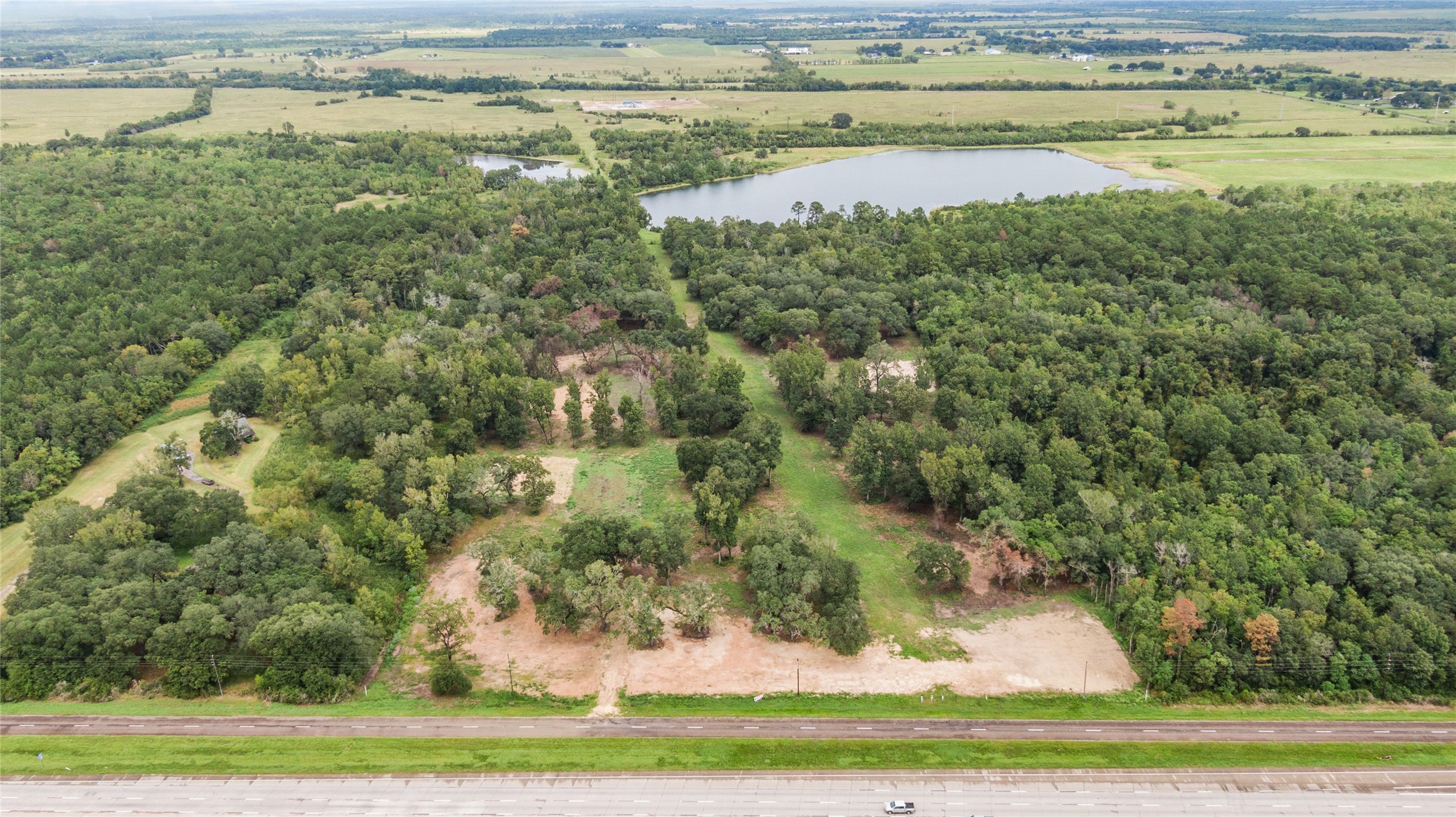 31901 Interstate 10 Hankamer, TX 77560 - Photo 8 of 12 a view of a lake with a yard