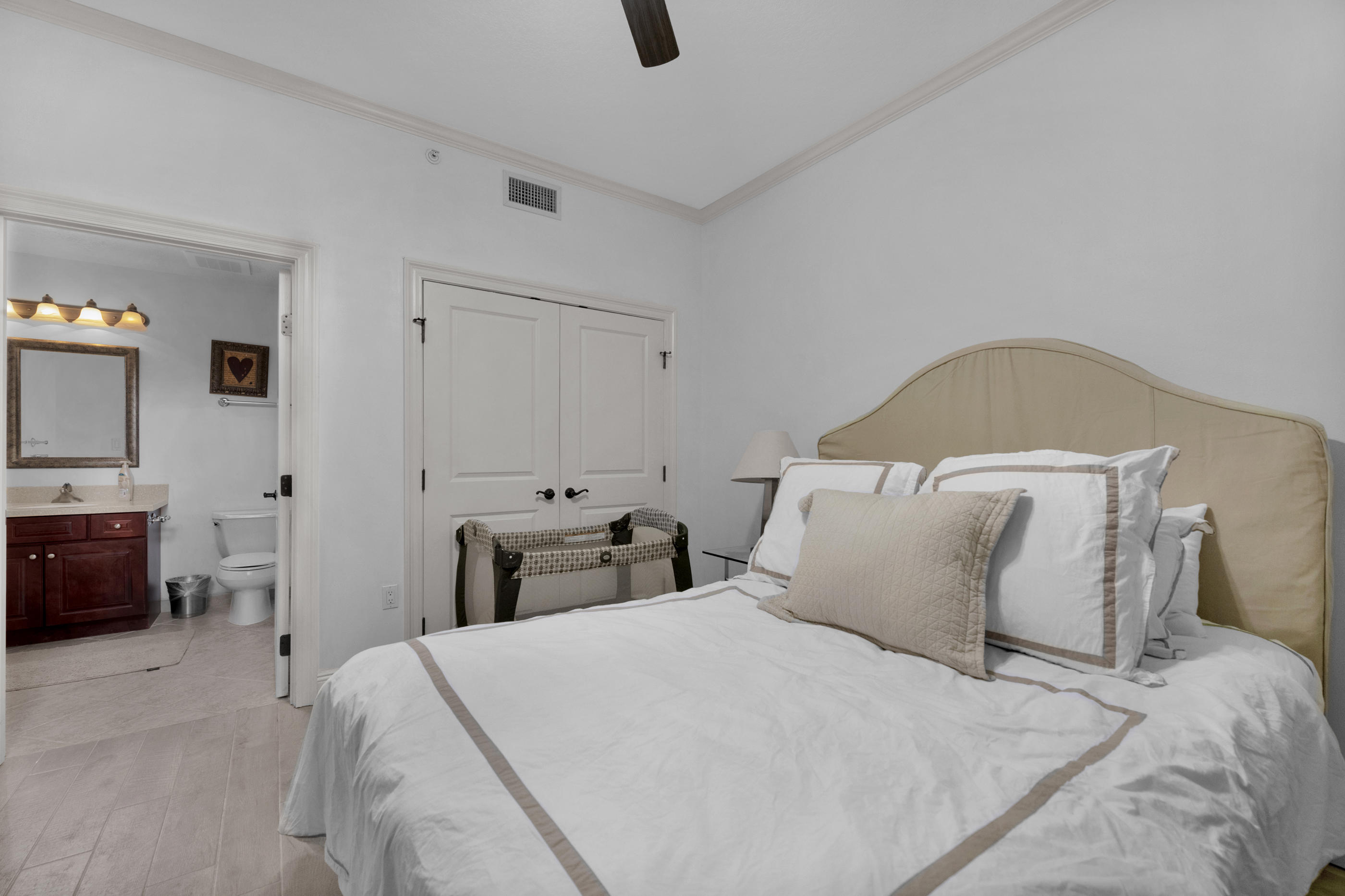 770 Harbor Boulevard, Unit 7E Destin, FL 32541 - Photo 20 of 38 a bedroom with a bed and furniture