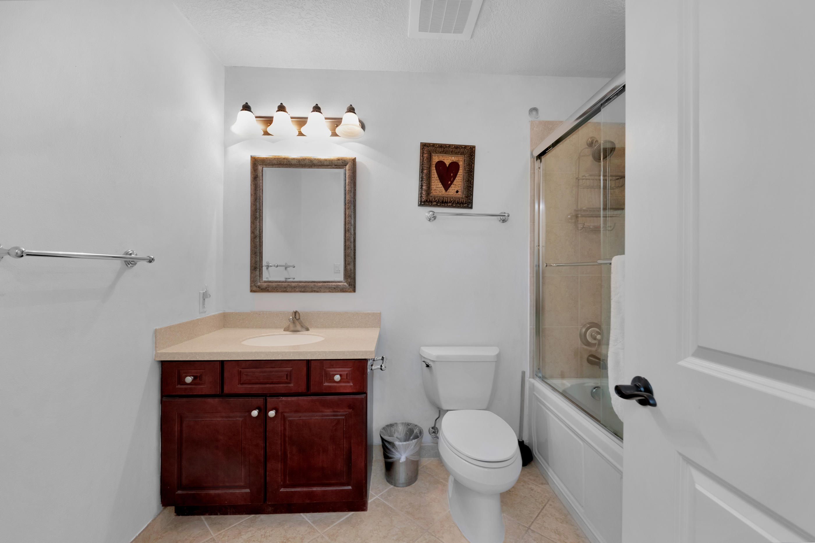 770 Harbor Boulevard, Unit 7E Destin, FL 32541 - Photo 21 of 38 a bathroom with a toilet sink and mirror