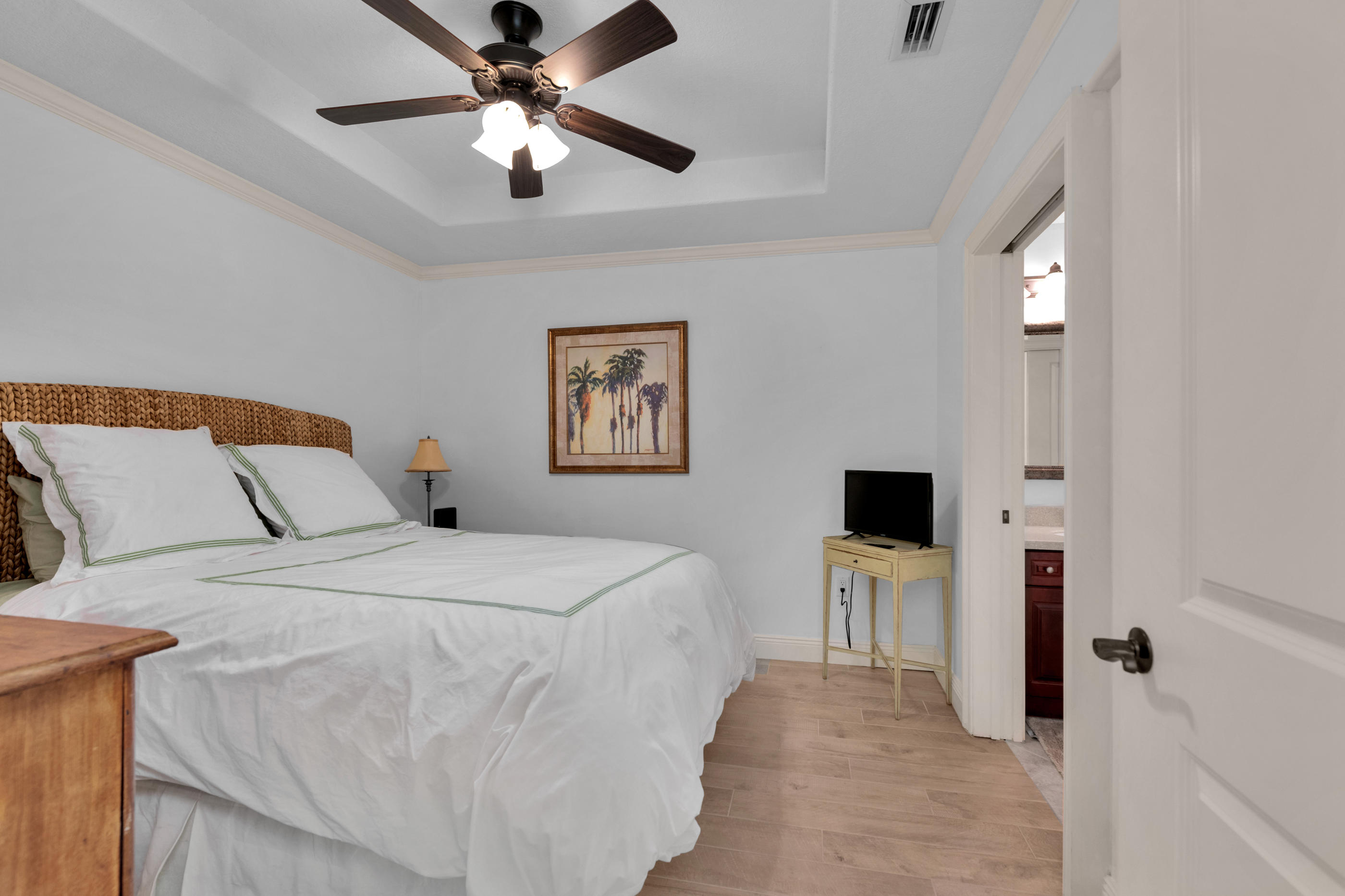 770 Harbor Boulevard, Unit 7E Destin, FL 32541 - Photo 23 of 38 a spacious bedroom with a bed and a chandelier