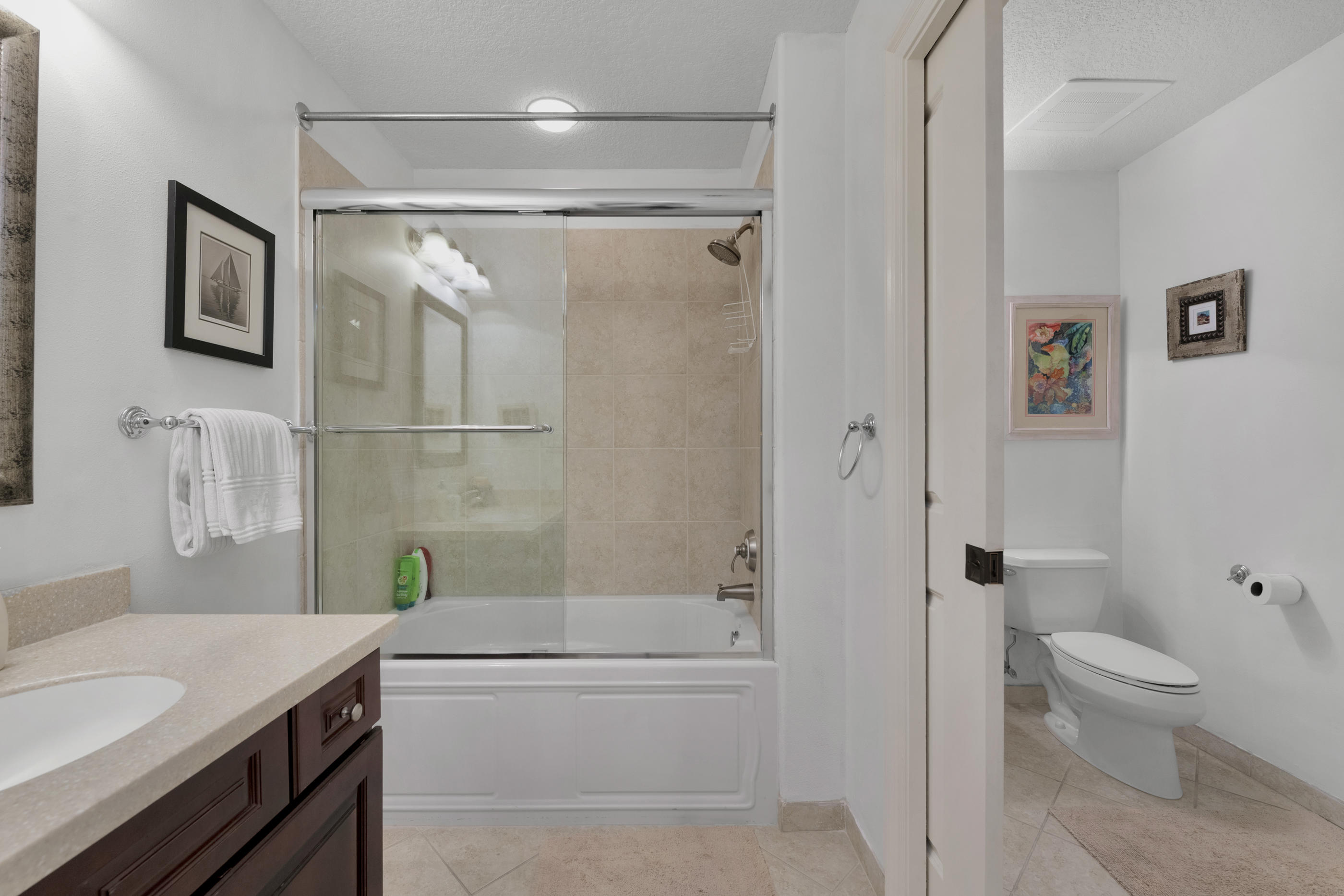 770 Harbor Boulevard, Unit 7E Destin, FL 32541 - Photo 24 of 38 a bathroom with a granite countertop sink toilet and shower