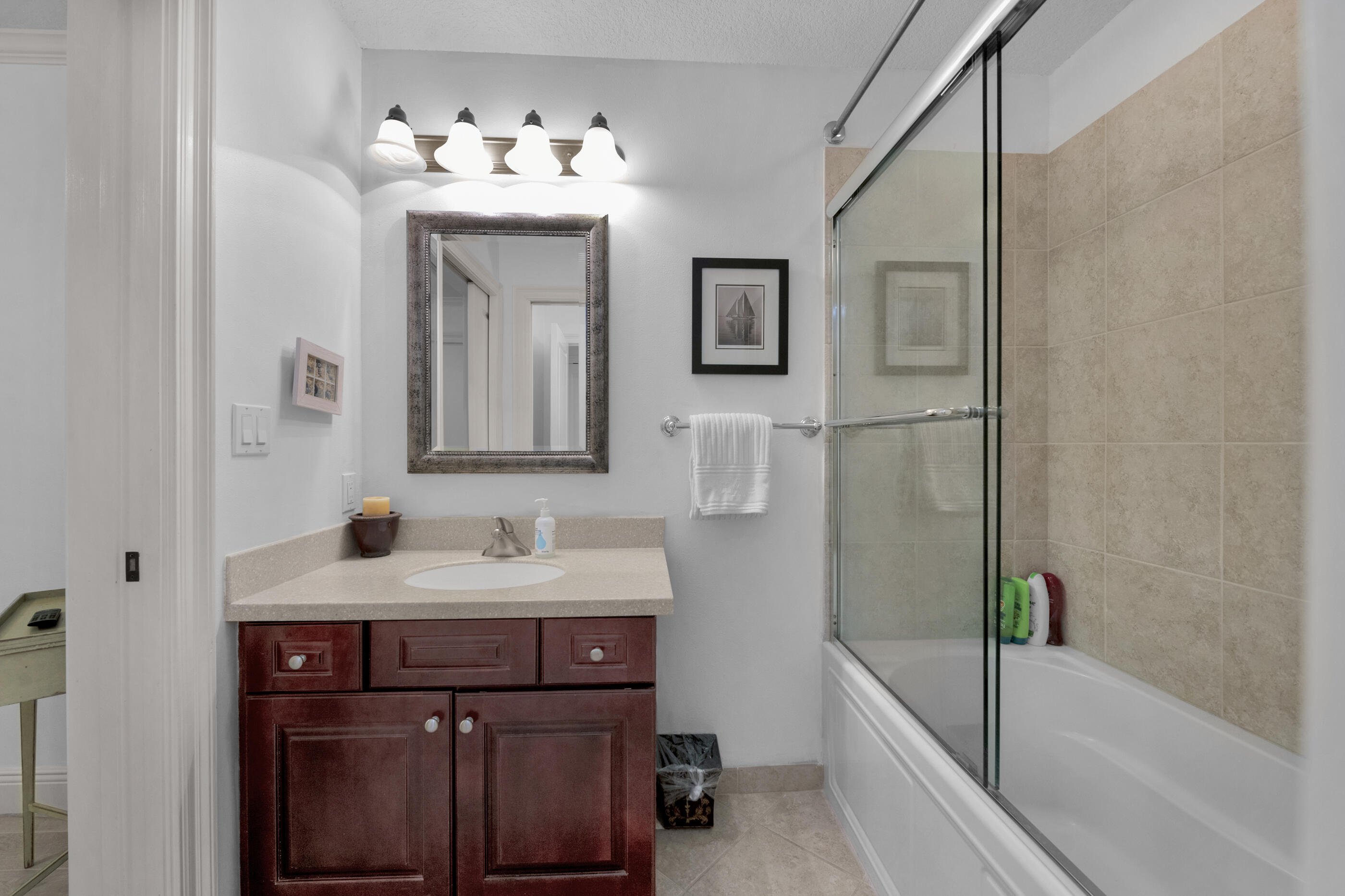 770 Harbor Boulevard, Unit 7E Destin, FL 32541 - Photo 26 of 38 a bathroom with a sink and a mirror