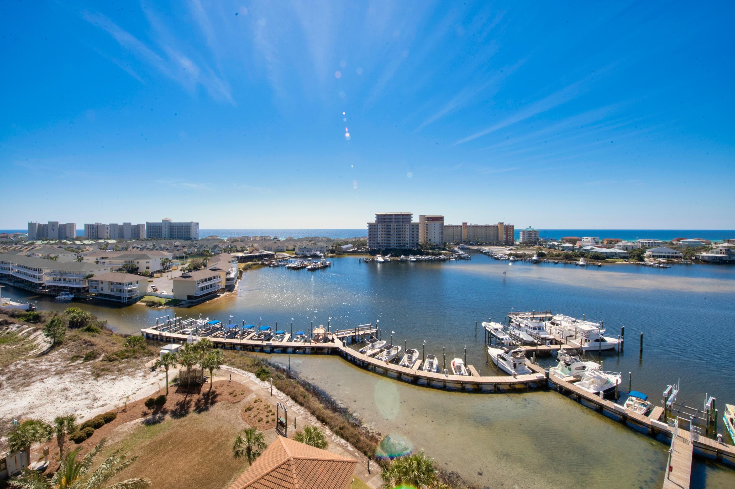770 Harbor Boulevard, Unit 7E Destin, FL 32541 - Photo 30 of 38 a view of a lake with boats and palm trees